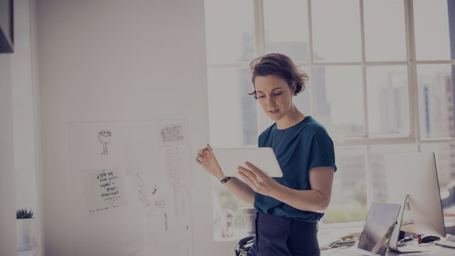 Businesswoman using digital tablet in office smal